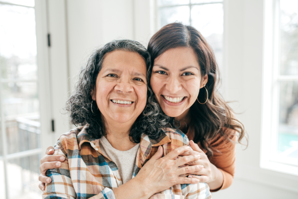 Two women smiling and hugging